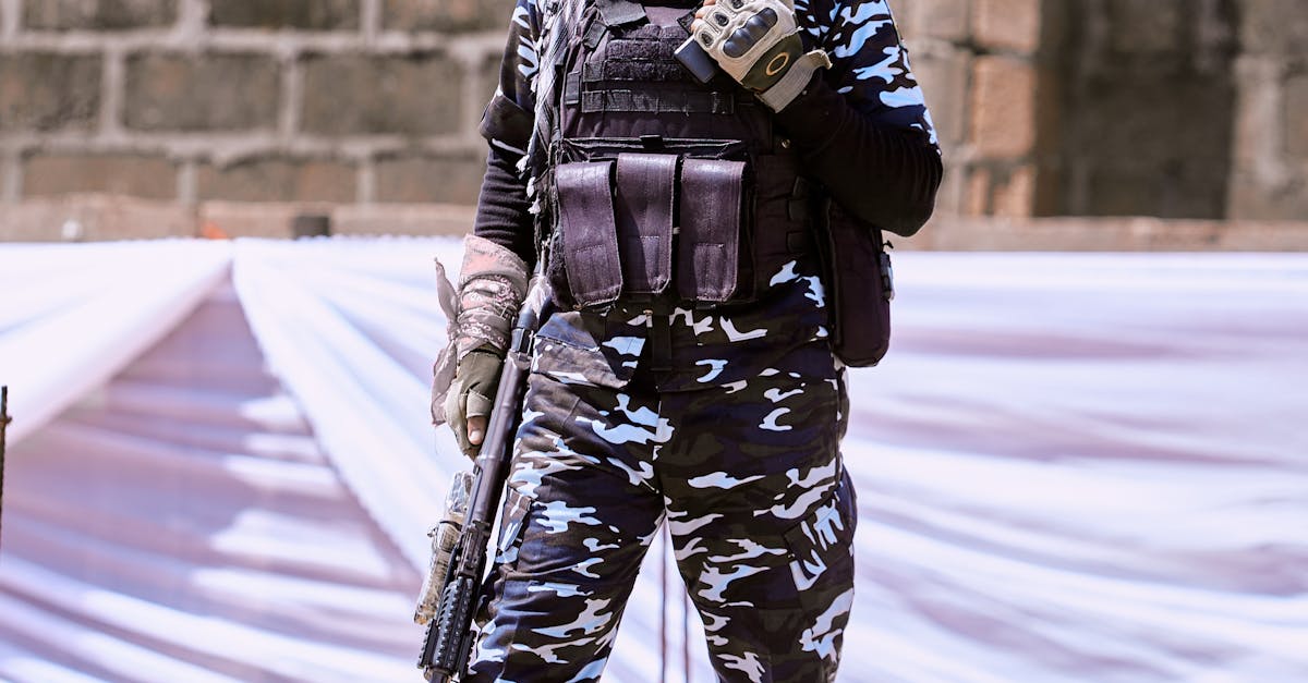 Armed police officer in full tactical gear standing outdoors in Abuja, Nigeria.
