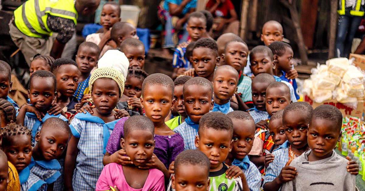 A group of smiling African children posing outdoors in colorful attire. Vibrant community spirit.